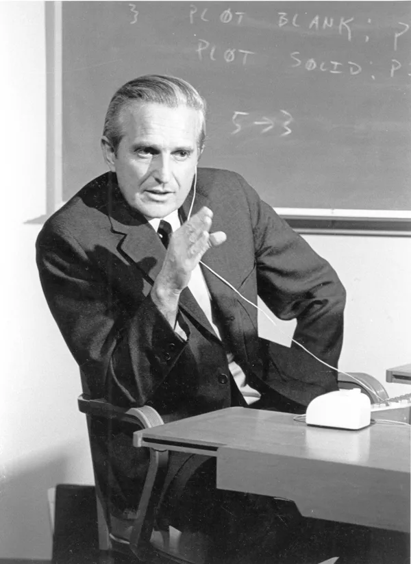 Douglas Engelbart seated at a computer workstation at SRI in 1968